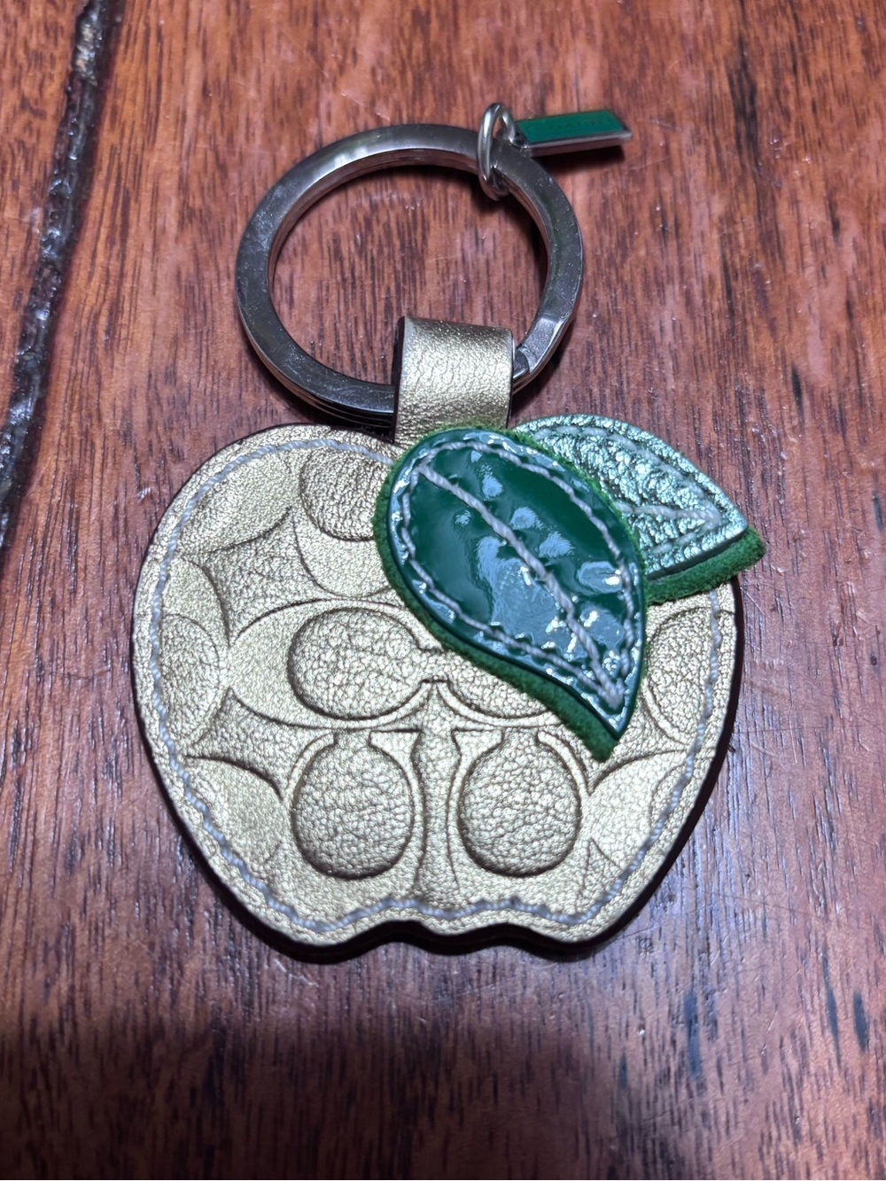 Coach gold Apple keychain